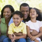Extended family sitting outdoors smiling