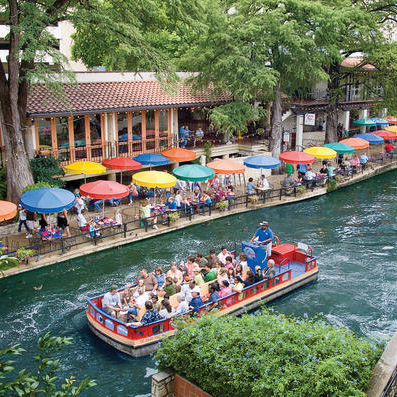 River Walk boat going by Restaurant patio seating