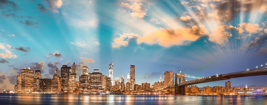 New York City Skyline with rays of light coming from behind the clouds