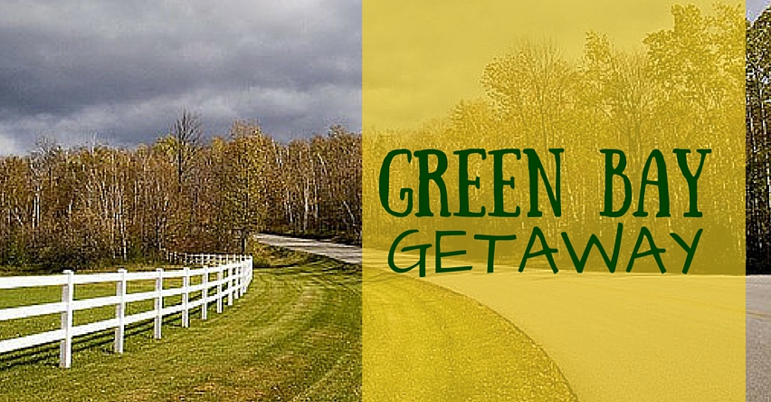 Green Bay Getaway blog title next to road into forest in the fall