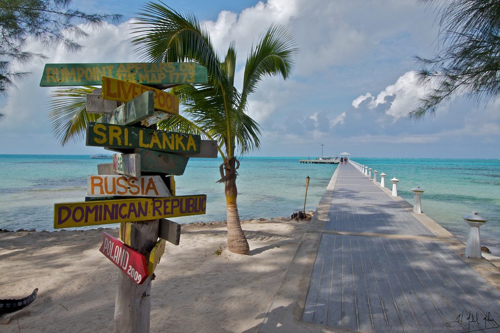 Cayman Islands dock with post sign for other monuments