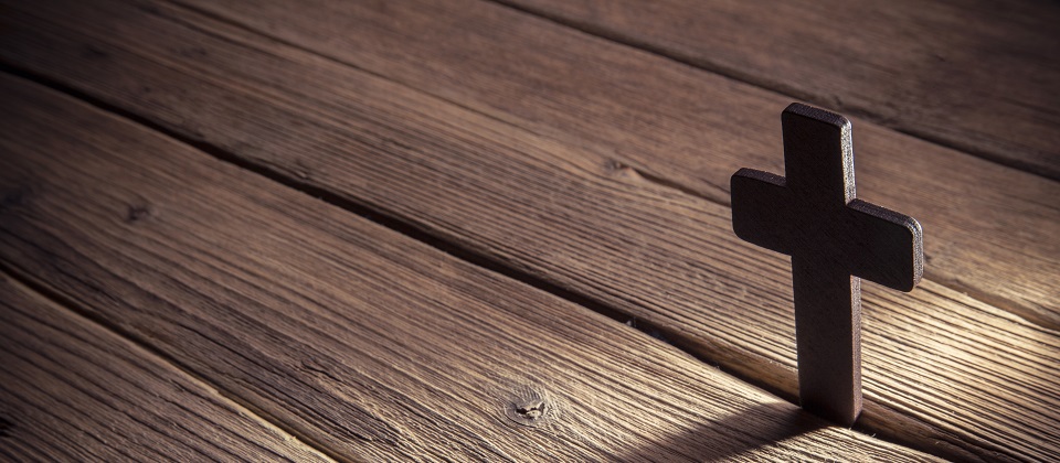 wooden cross on wood background