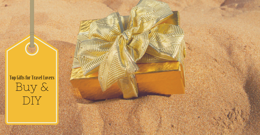 Top Gifts For Travel Lovers - Buy & DIY blog title on gold gift tag next to golden present in the sand