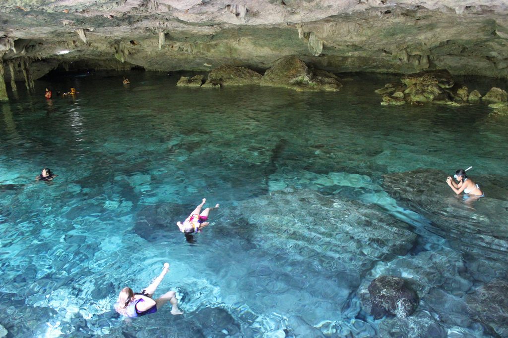 Tourists Swimming in cave Tulum
