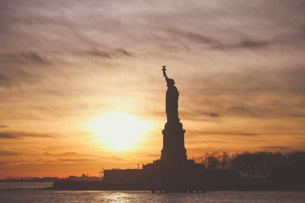 Silhouette of statue of liberty at sunrise