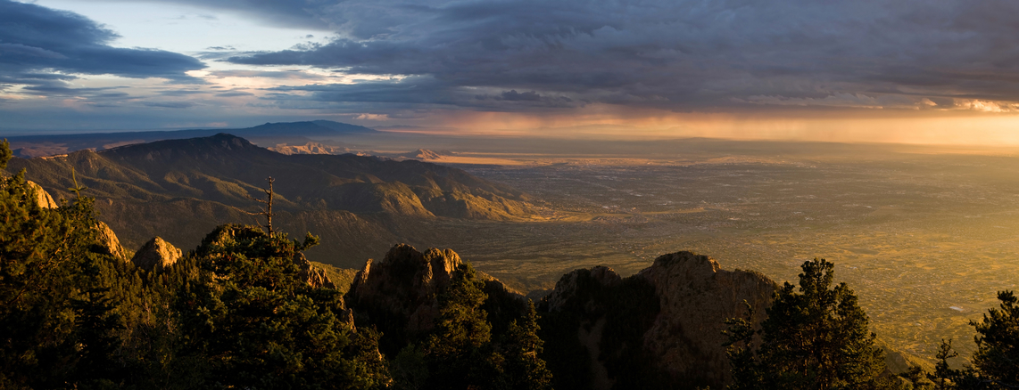 Panorama of majestic sunset over the Chihuahuan Desert and the city of Albuquerque, New Mexico, as seen from the peak of the Sandia Mountains