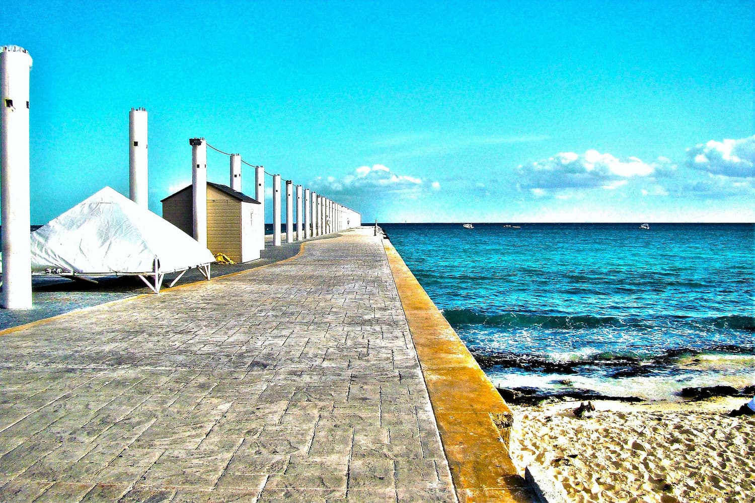 Pier on sandy bech on a bright day