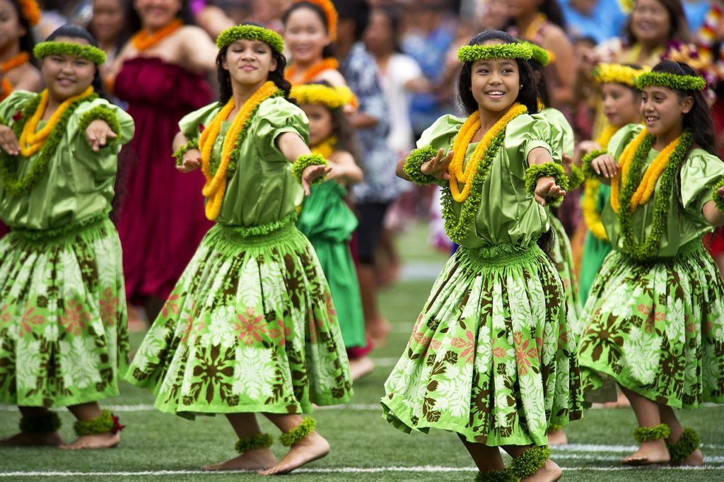 Several Hawaiian Luau Dancers dressed in green and yellow