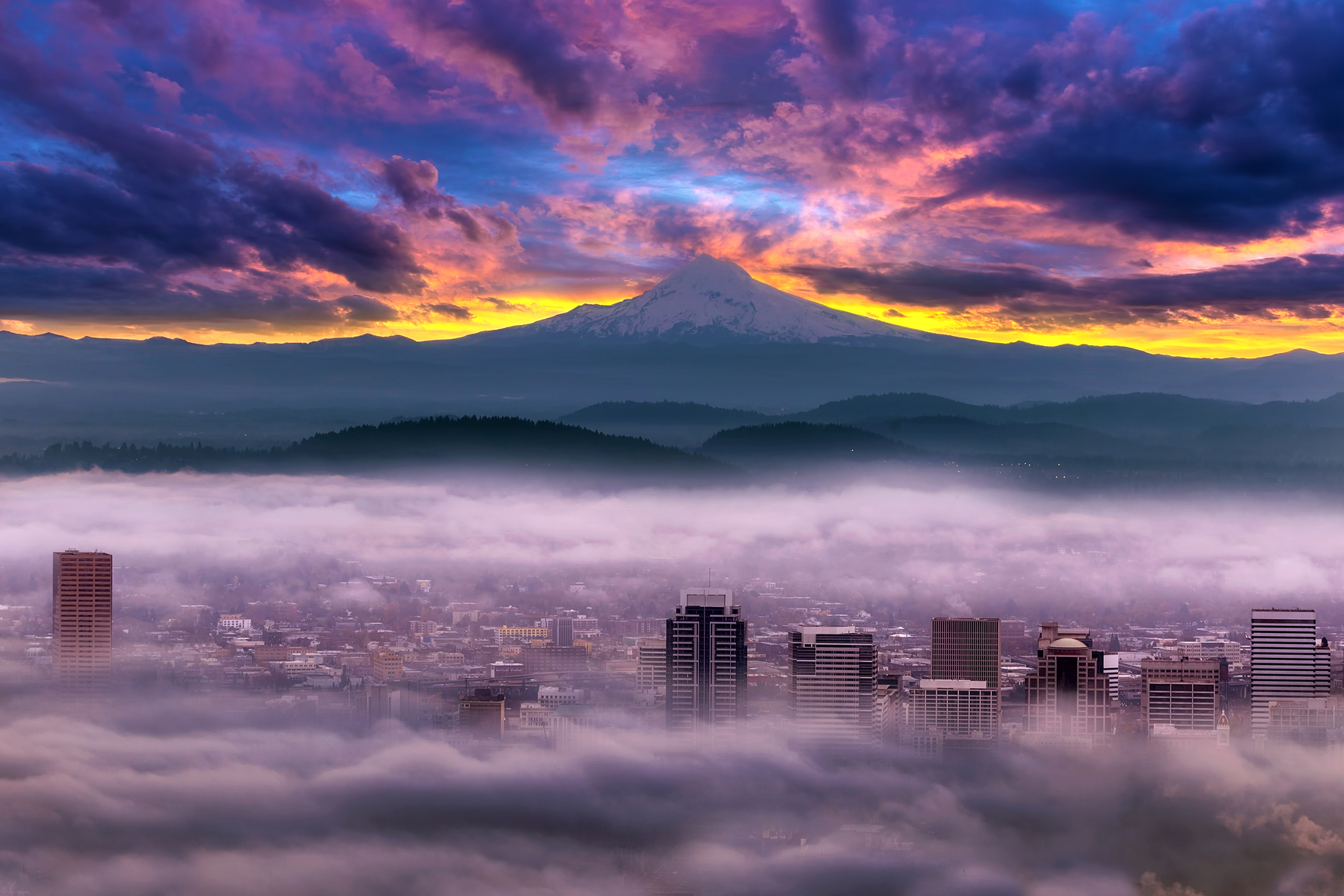 Dramatic colorful sunrise over Mount Hood and foggy Portland Oregon city downtown