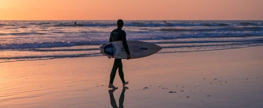 Man with Surf board on beach