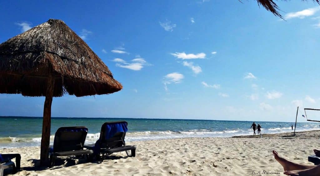 Cancun Beach with lounge chairs and straw umbrella Credit Danielle Bopp