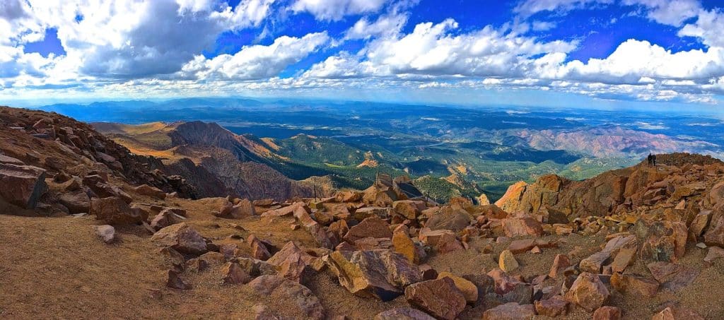 Mountain with large rocks overlooking rolling hills in valley