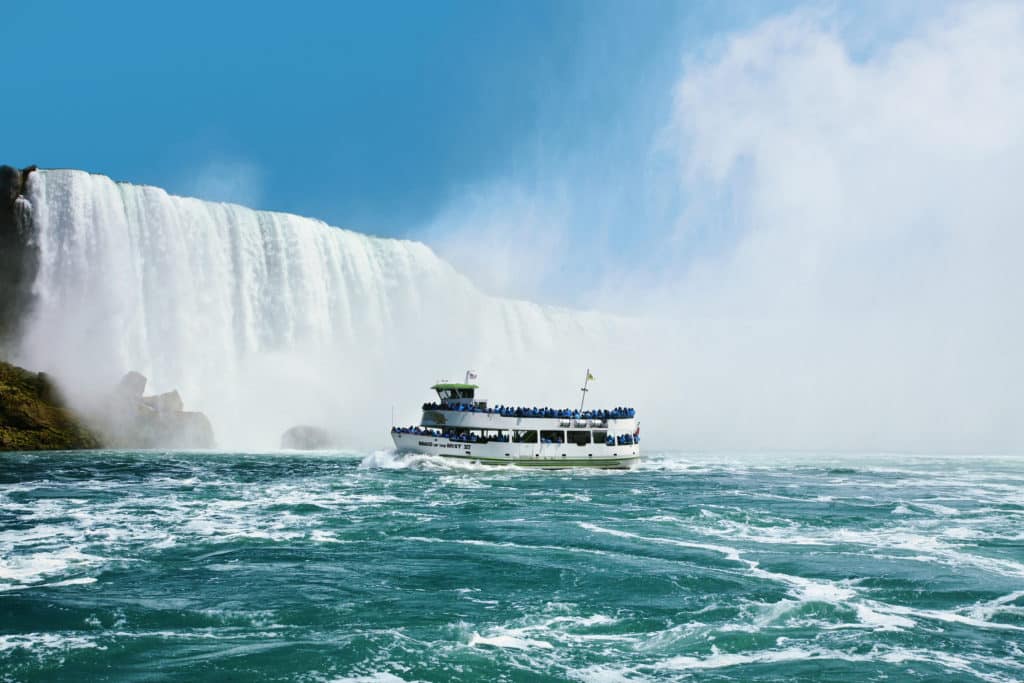 Maid of the Mist VI boat with tourists looking at falls